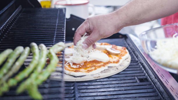 Cooking pizza on outdoor gas grill.