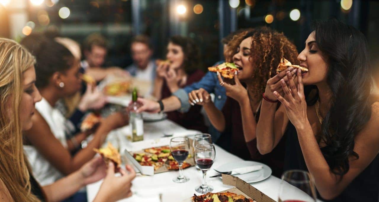 Group-of-friends-eating-pizza-and-drinking-wine-e1517317917865